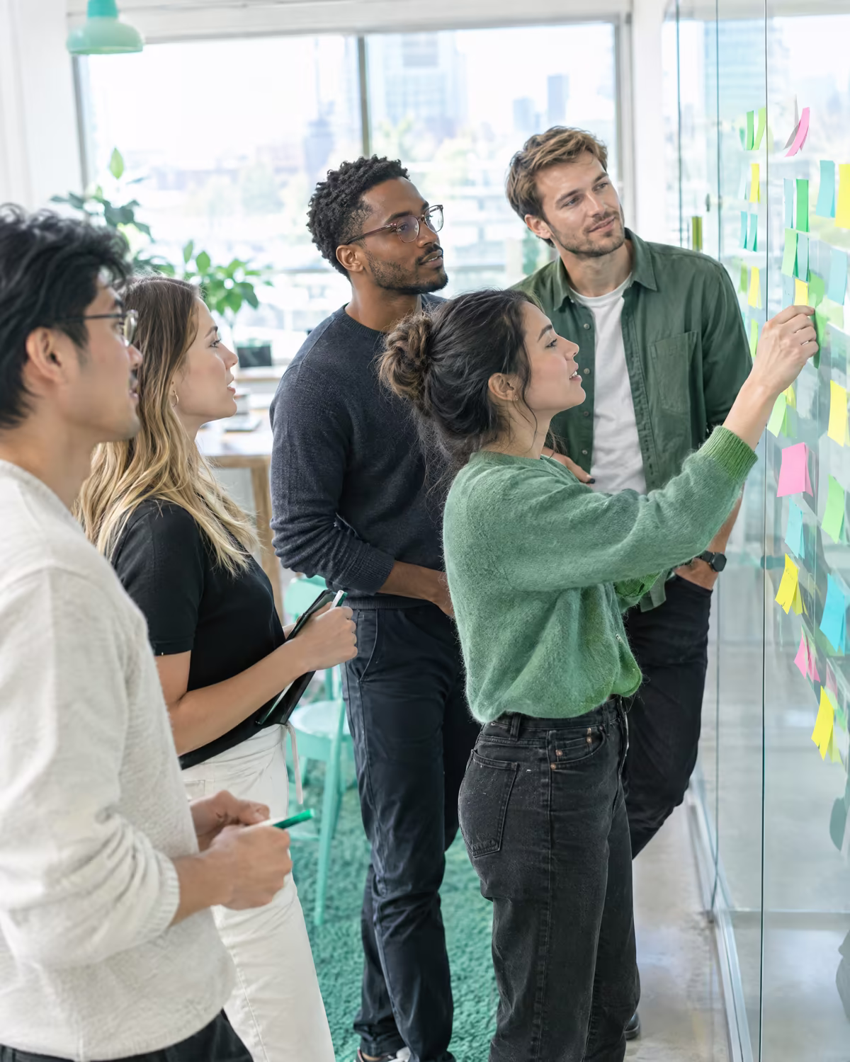 A project team planning a sprint on a sticky-note wall